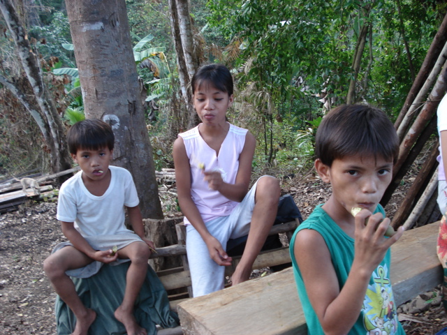 Children snack on tamarind pods