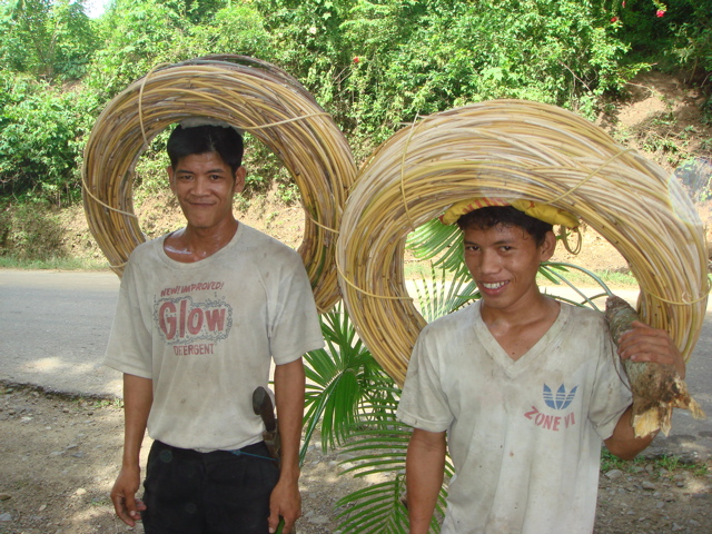 Boys gather rattan from the jungle for the baskets.